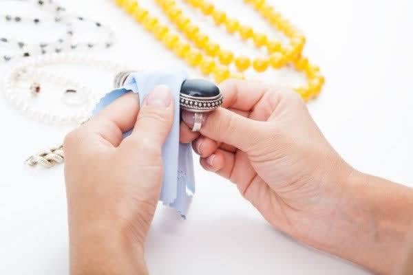 Cleaning imitation jewelry with a soft cloth